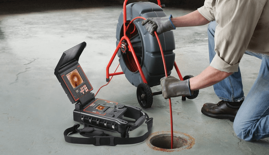 Plumber puts a camera into the sewer line and video records the sewer line for buyers.