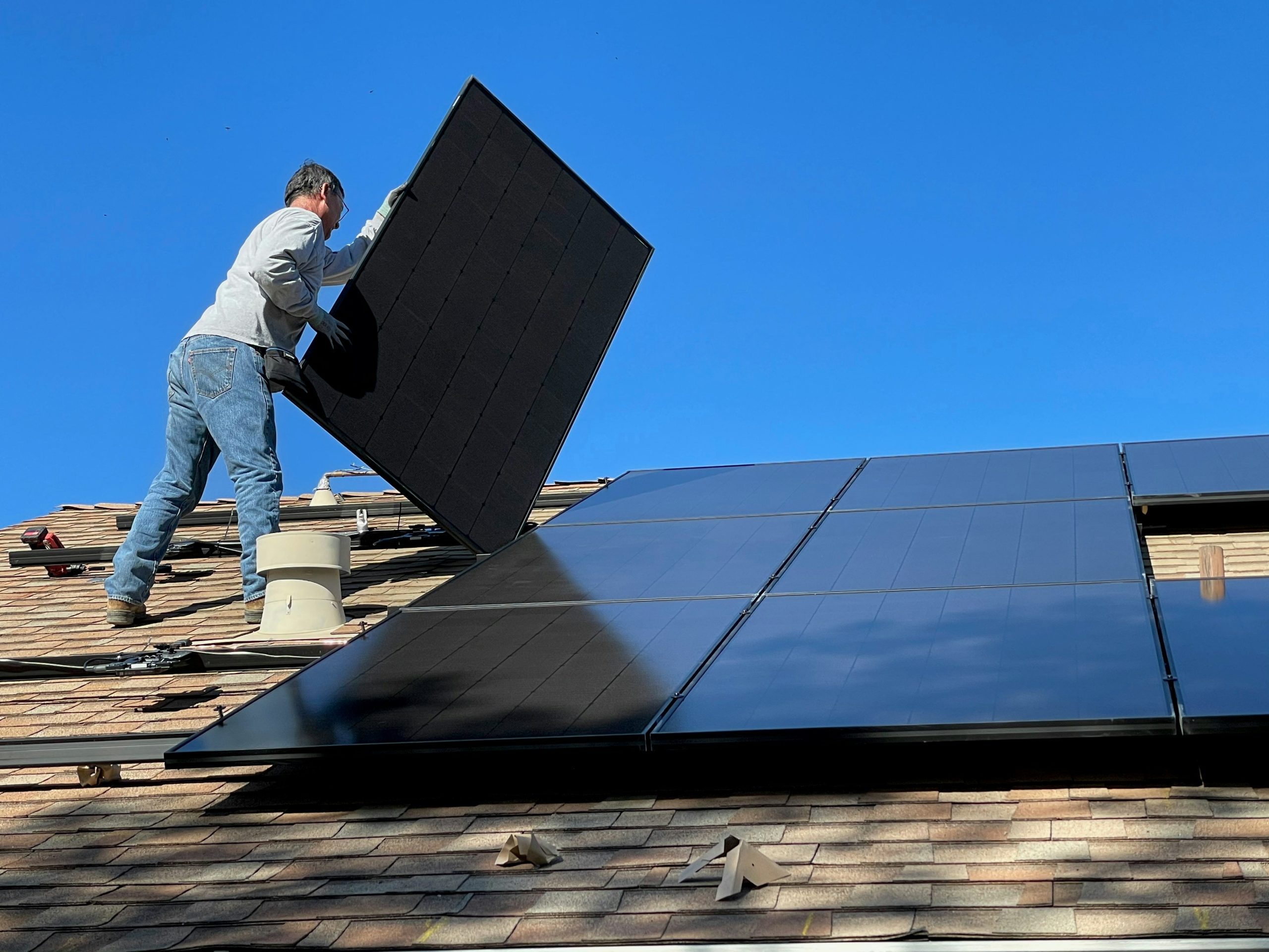 Rooftop solar panels in Tucson soak up the desert sun during peak summer conditions.